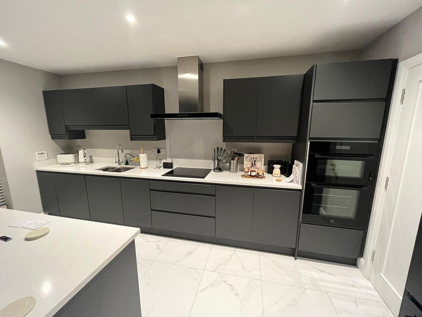 Black Handless Kitchen with White Stone Countertop