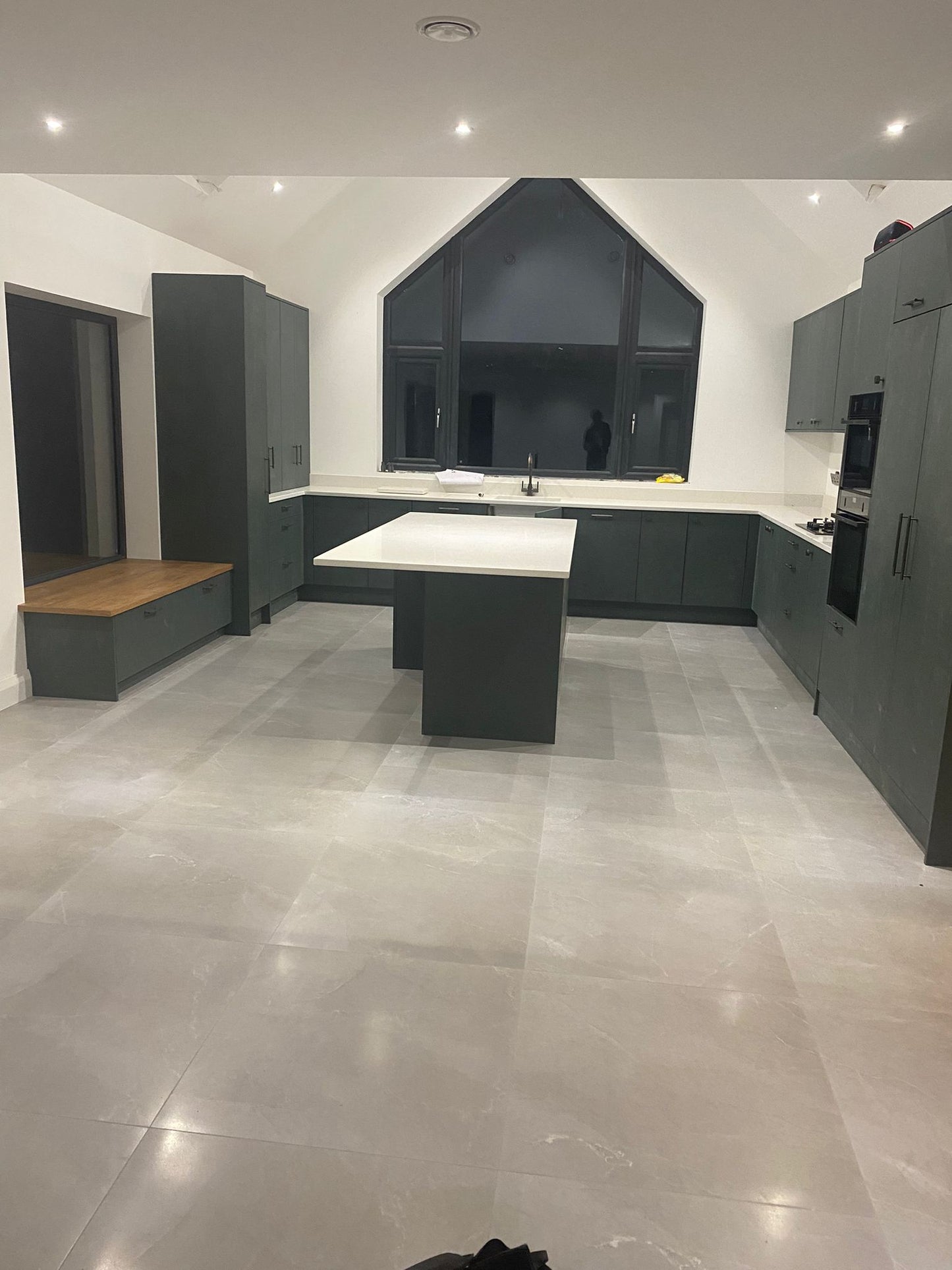 Dark Kitchen Fitted to 3 Walls with Bench