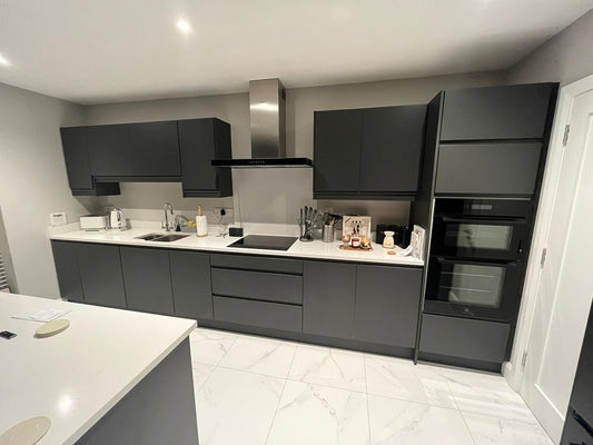 Black Handless Kitchen with White Stone Countertop