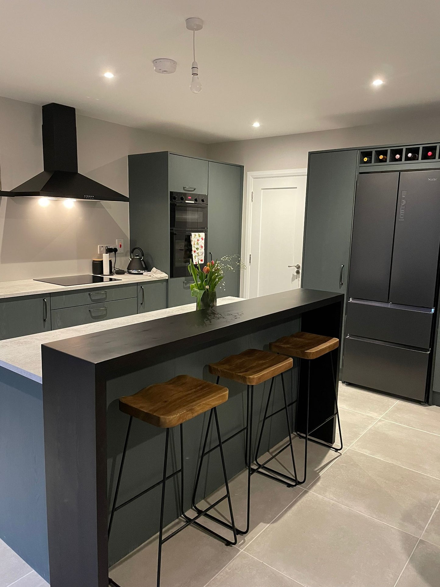 Dark Grey Kitchen with White Countertop and Island Feature